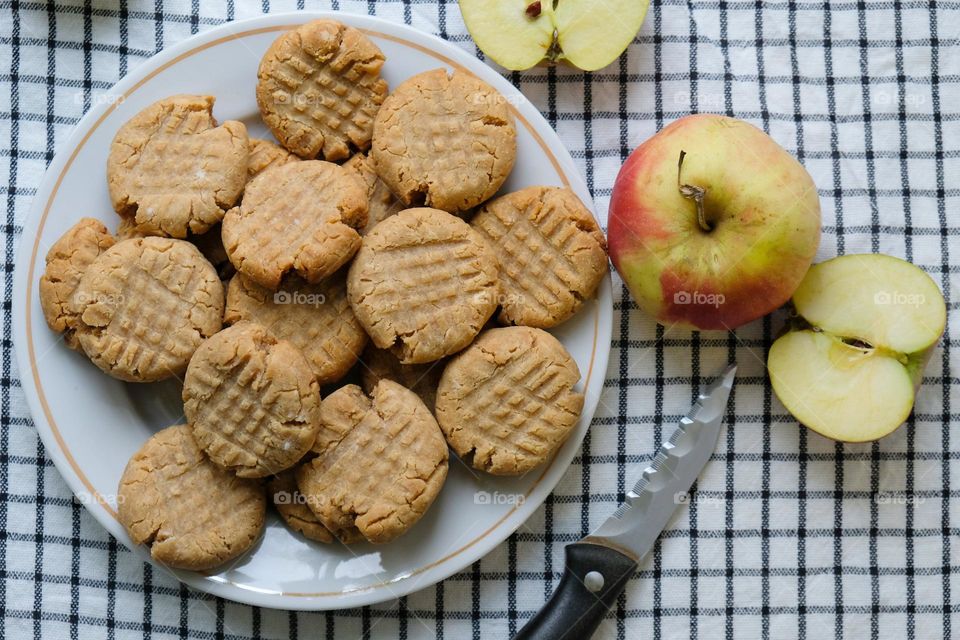 Flat lay with American peanut butter cookies and apples on the checkered napkin