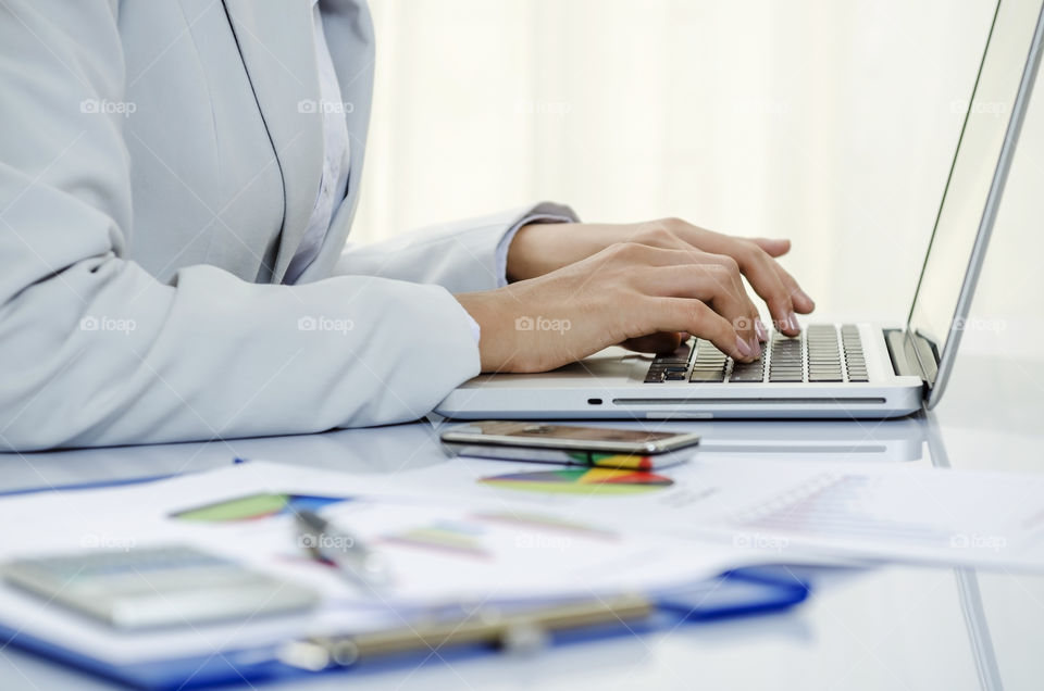 Businesswoman typing in her laptop