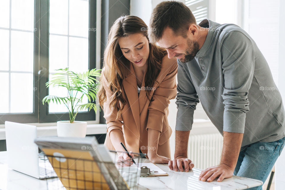 Young woman business woman girl with man working together in office room 