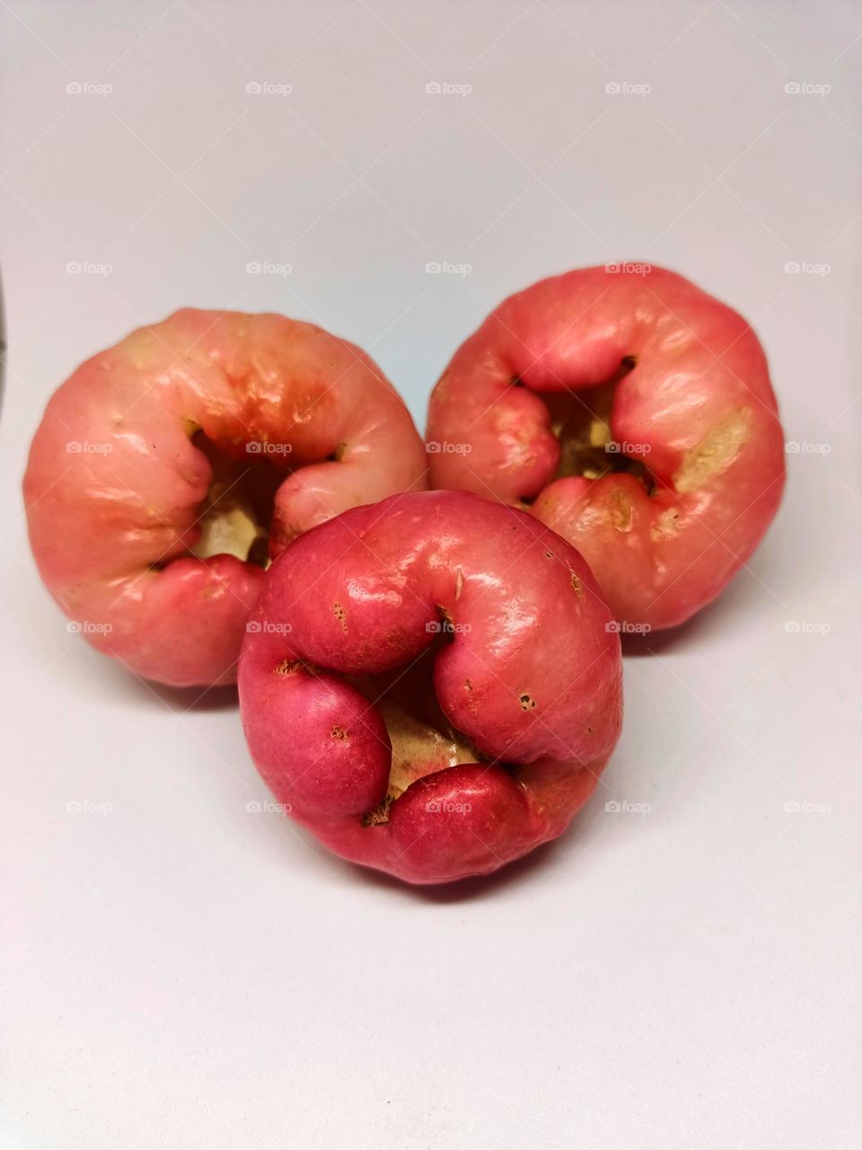 Close up of wax apple isolated on white background. Selective focus, underexposed, blurry, low light, too soft