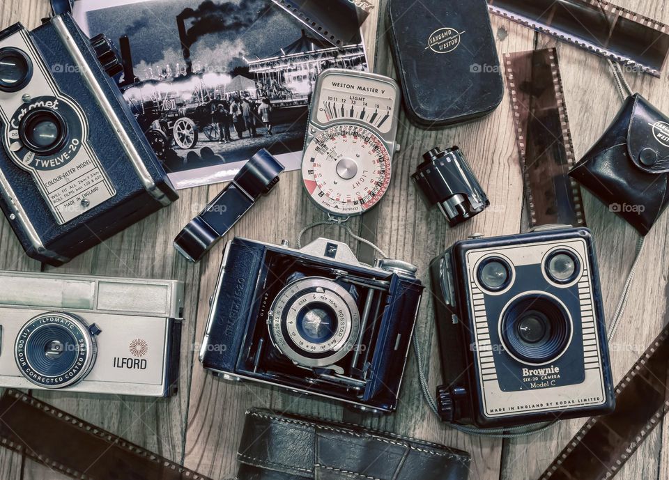 Vintage cameras and accessories flat lay on wooden background 