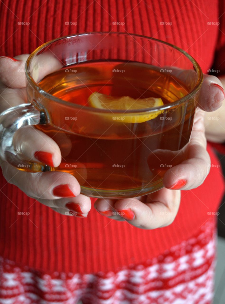 cup of tea in the female hands cozy winter