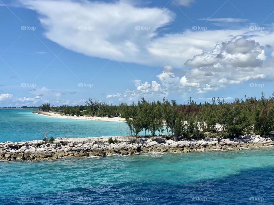 Blue and turquoise water at the entrance to a harbor