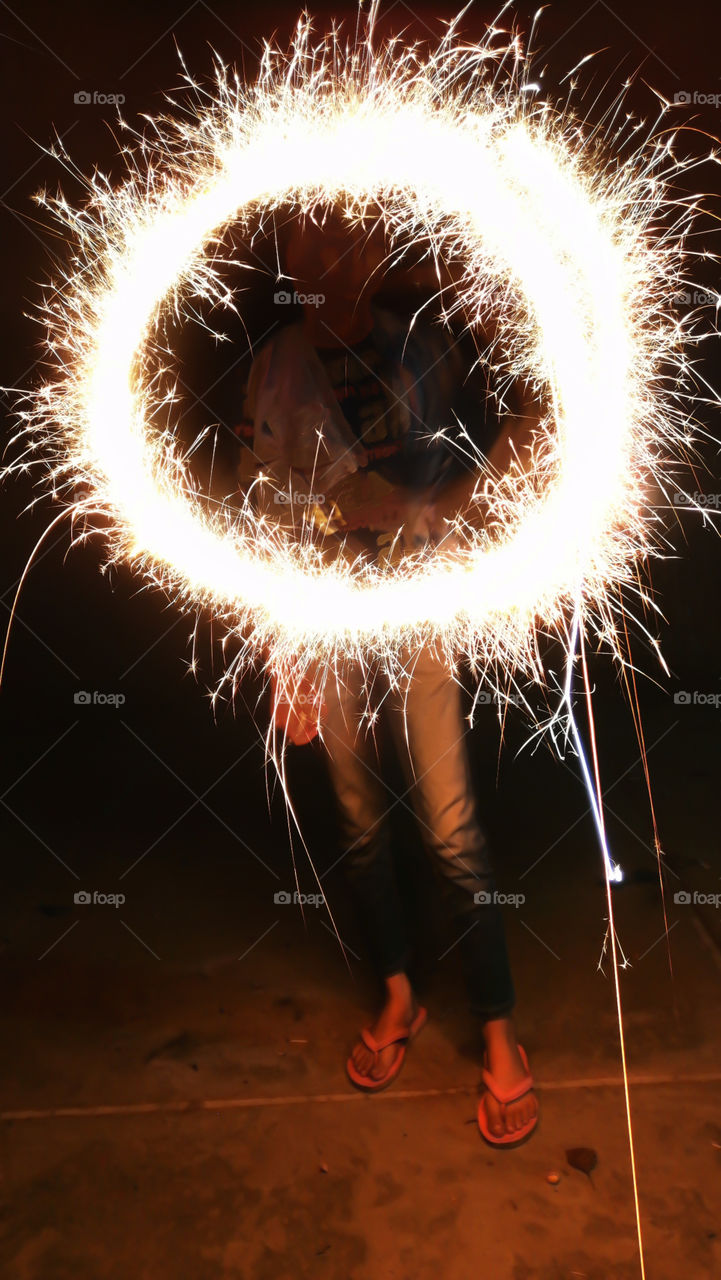 Kid enjoy their Sparkler in circular shape on eve of Diwali Festival night.