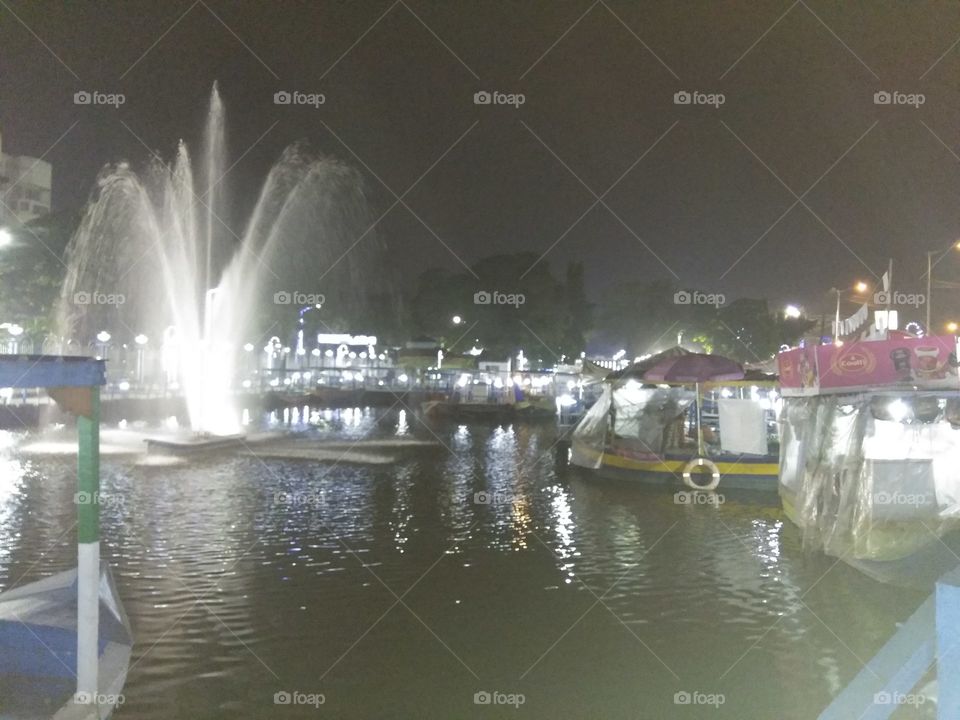 waterbody with floating market, evening light n sound,