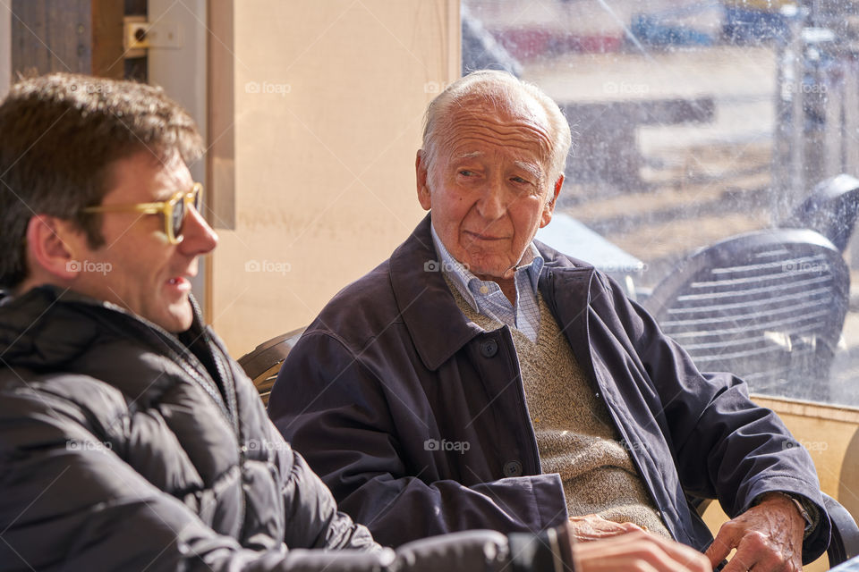 Close-up of two men sitting in restaurant