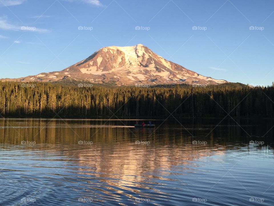 Reflection of trees and mountain on lake