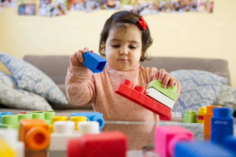 my little girl playing with building blocks