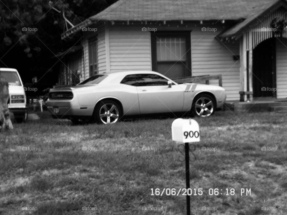 chevy car. this is a picture of a chevrolet camaro that is parked in the yard