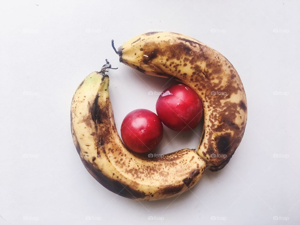 Fresh and ripe bananas and berries 