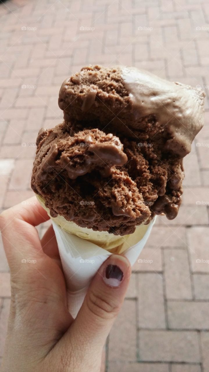 Woman holding chocolate ice cream cone