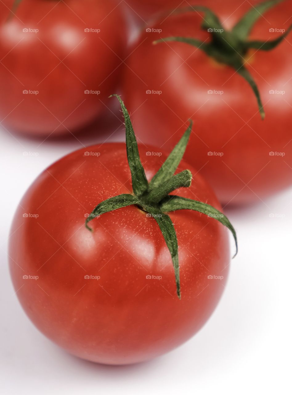 Red ripe tomatoes on a white background