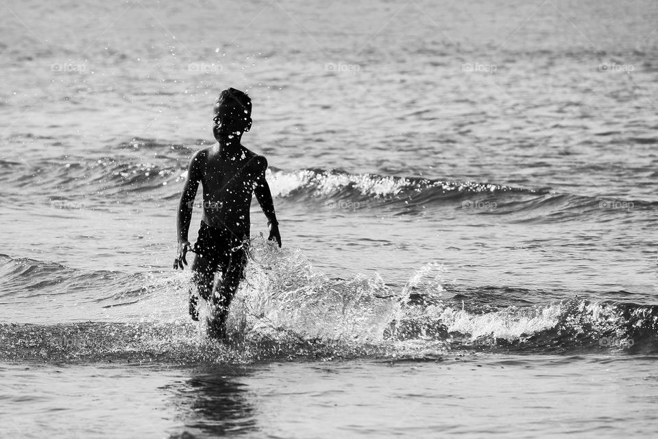 Boy plays with waves