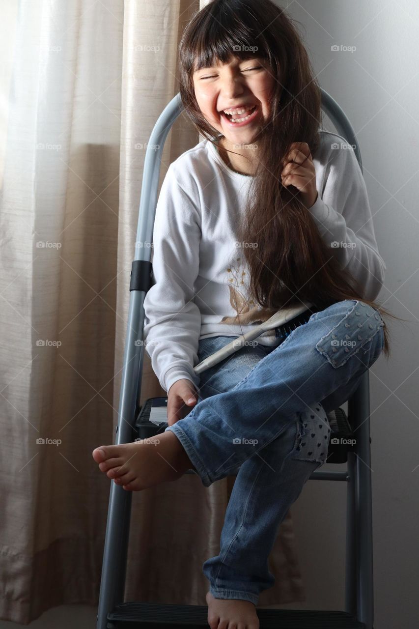 Happily laughing girl with long hair