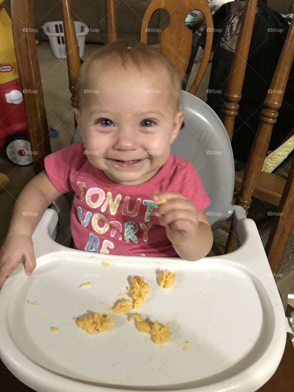 Toddler girl eating eggs