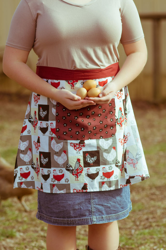 Woman with apron holding eggs