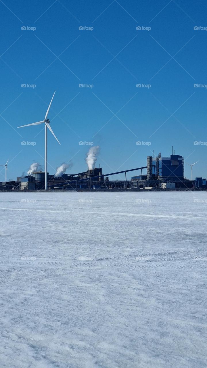 Outokumpu Oyj Steel factory in Tornio, Finnish Lapland. Windmills by the se making electricity.