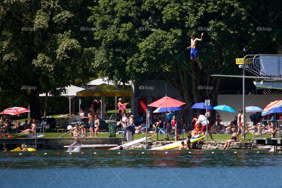 People Having Fun At Lake In Summer