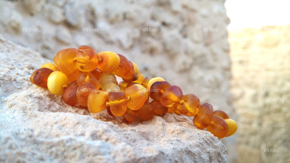 Amber necklace on stone