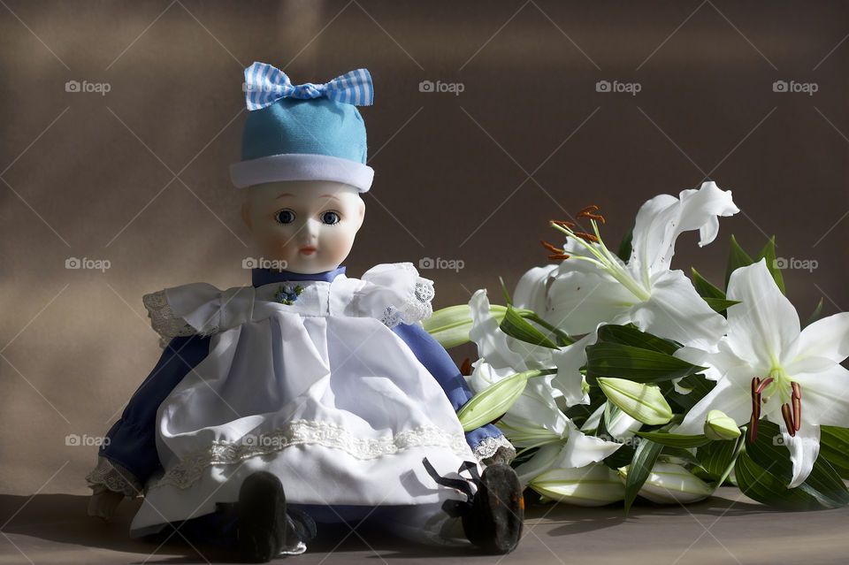 Old doll with lilies