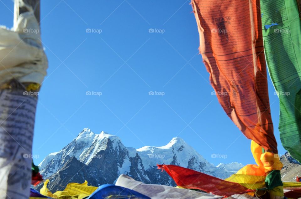 The mountain pick has been shown between orange flag in Gurudongmar lake ...