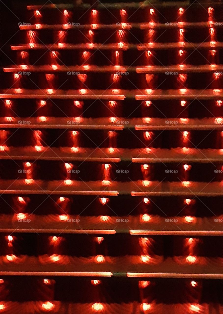 What are these? They are rectangular in shape and well lit...... They are the staircase of a cinema hall.