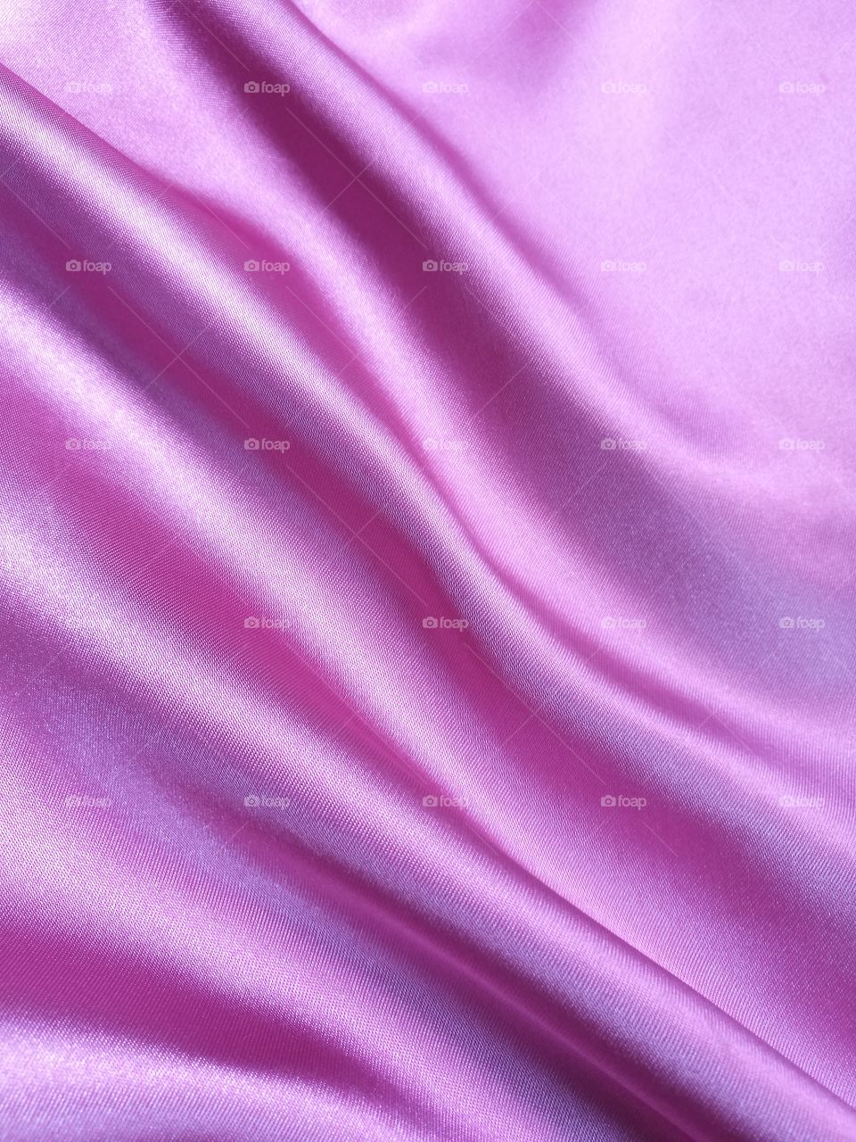 Background of beautiful pink satin fabric texture.