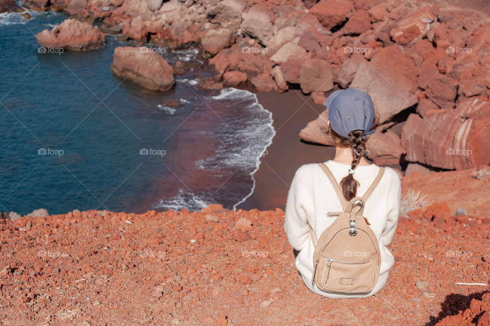 Girl looks at the ocean