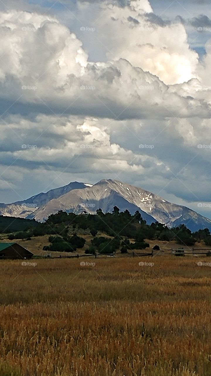 Spectacular clouds billowing above majestic Mt. Sopris intrigue the eye on a warm summer evening.