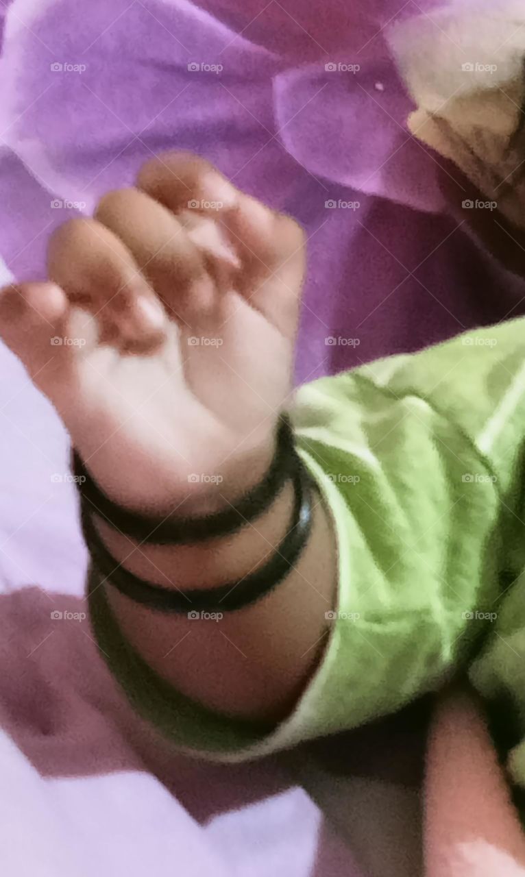 This beautiful ❤️😍 hand of two months baby girl 🐥😍. Baby is sleeping in her bed and playing joyfully with her toys!!🪀🧸