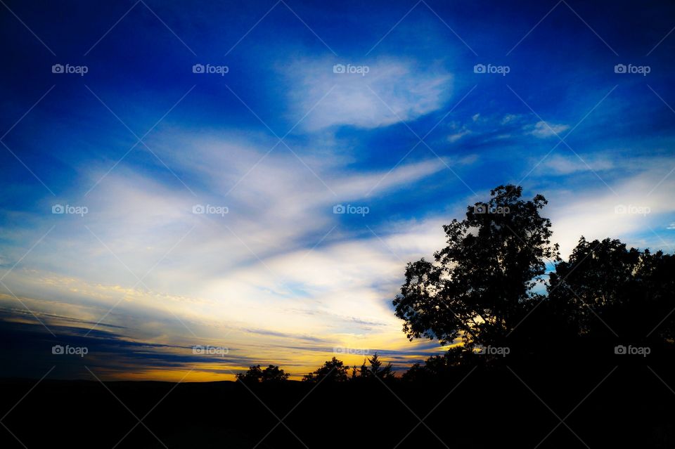 Landscape silhouette with sunset colored sky