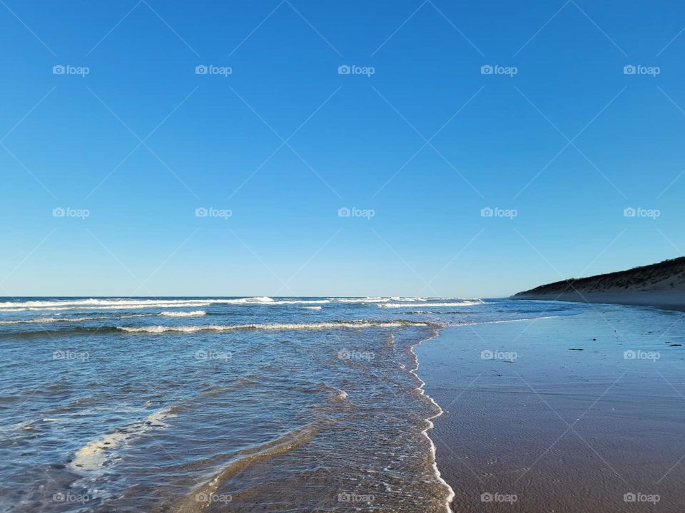 Atlantic ocean at capecod sandy beach and blue skies