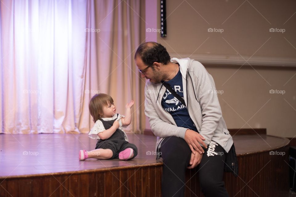 baby girl talking to her father in a serious conversation