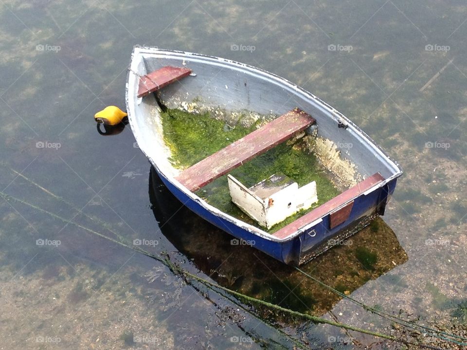 Old dinghy boat in harbour