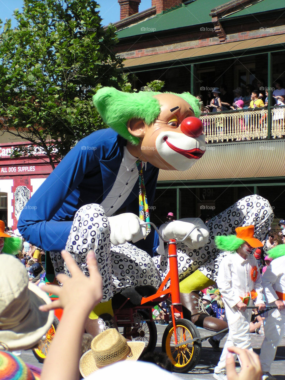 Large clown riding a trike