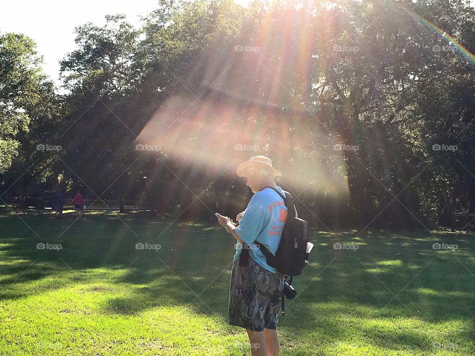Hiker bathed in sun rays. 