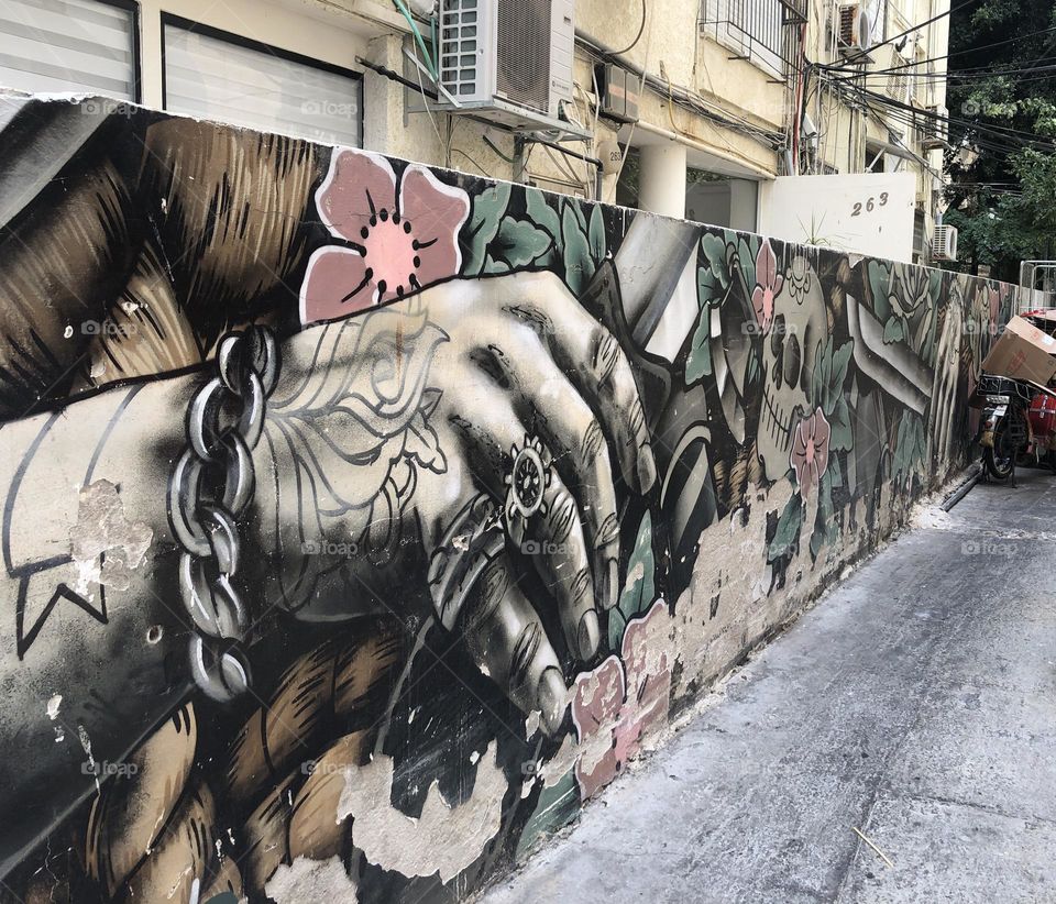 Colourful and old street art on a wall