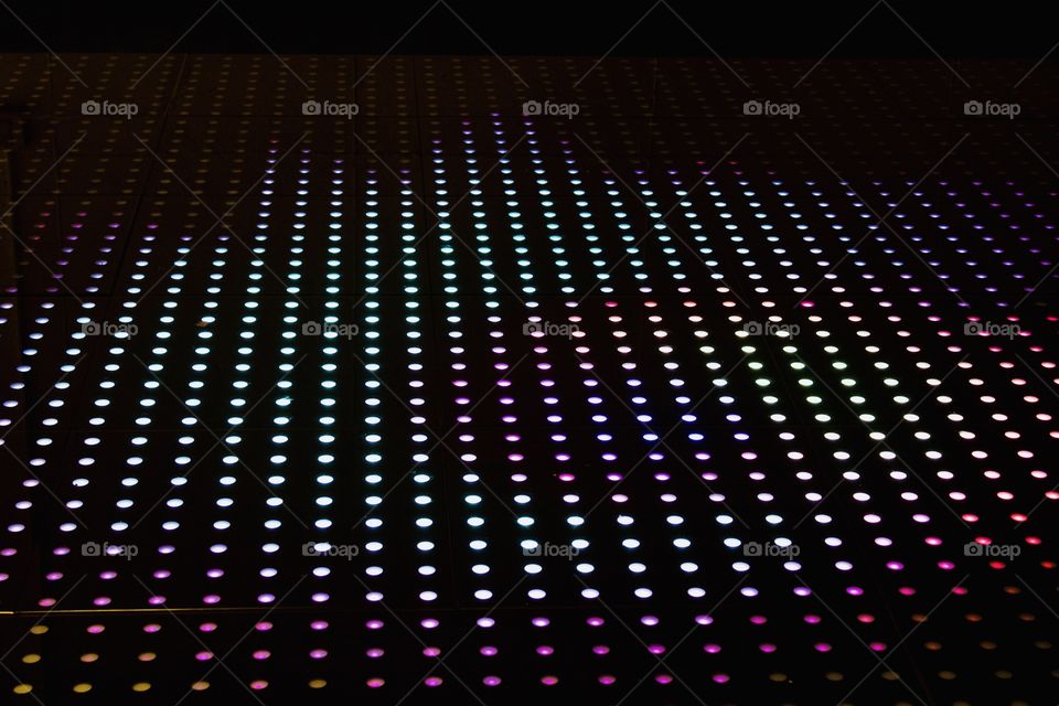 Angular view of multi-colored lighted circles on black background