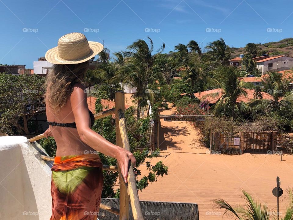Woman with hat on rooftops 