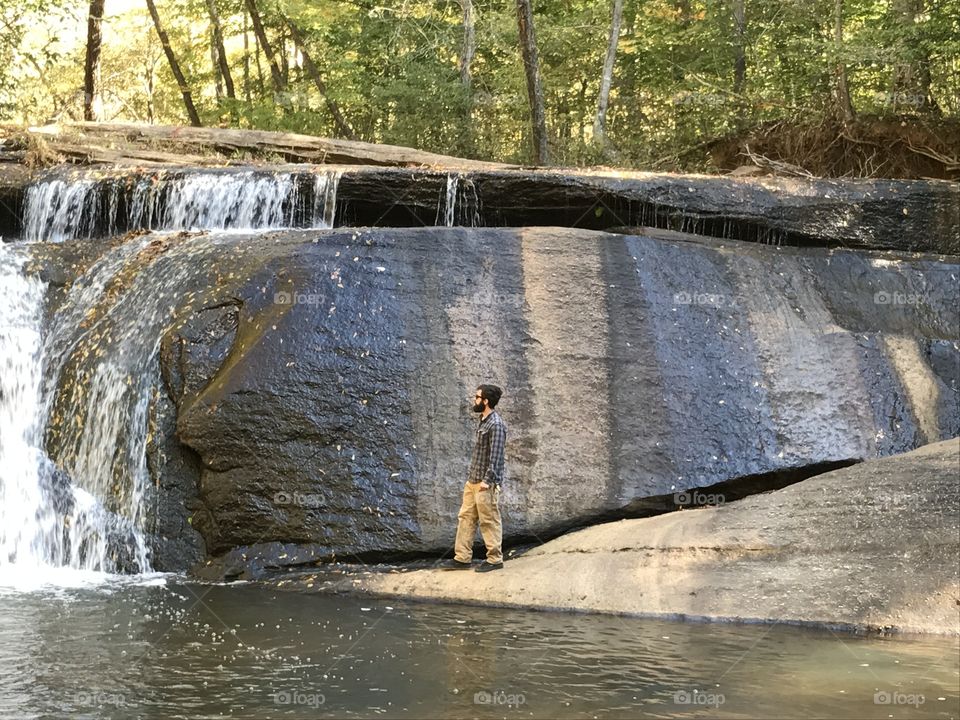 Hipster at a waterfall