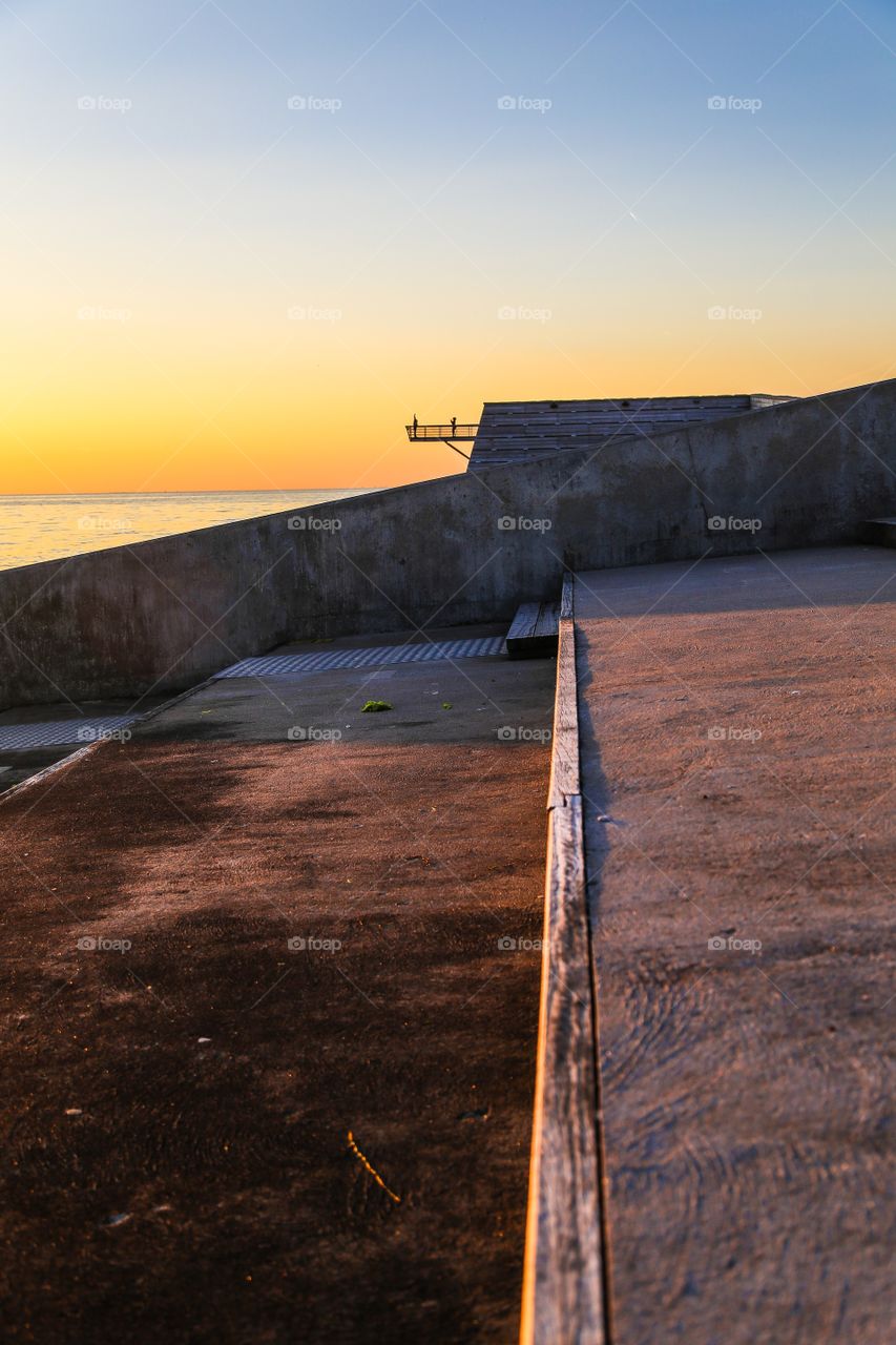 Construction and architecture by the sea in sunset