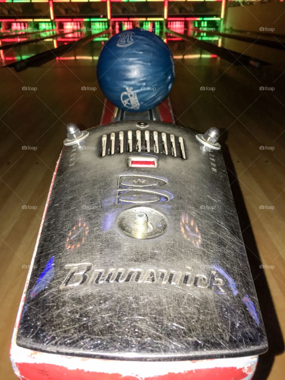 Bowling alley closeup bowling ball returned Brunswick 