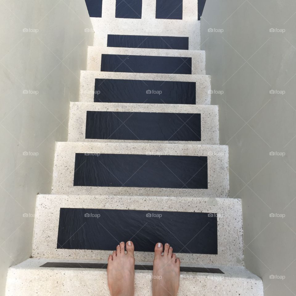 Female feet in feet stand on outdoor stone stairs first person view great for any use.