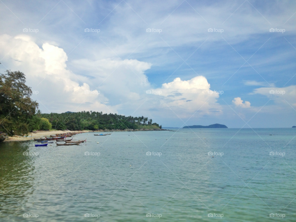 beach clouds boats water by twilite