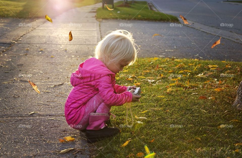 Little girl taking photograph with camera