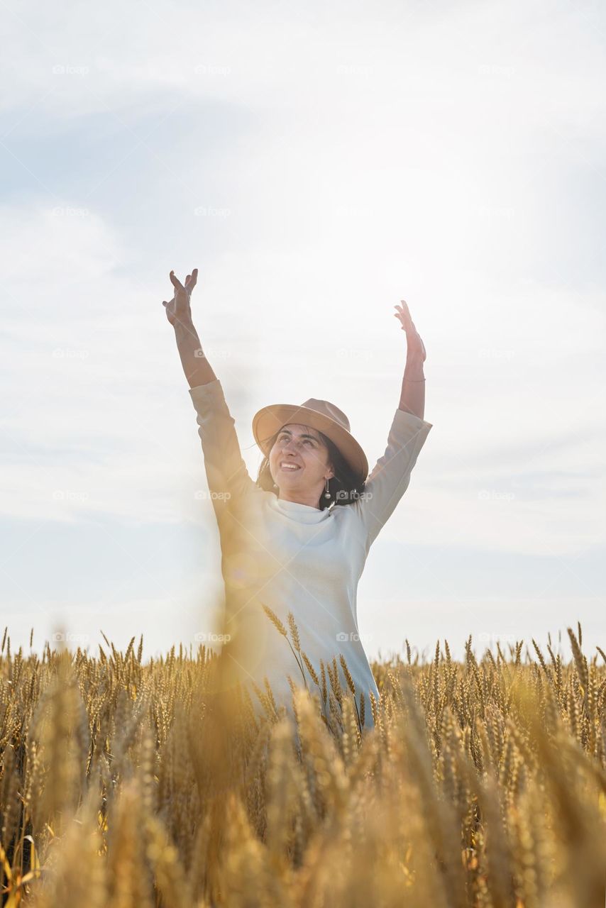 happy woman in wheat field