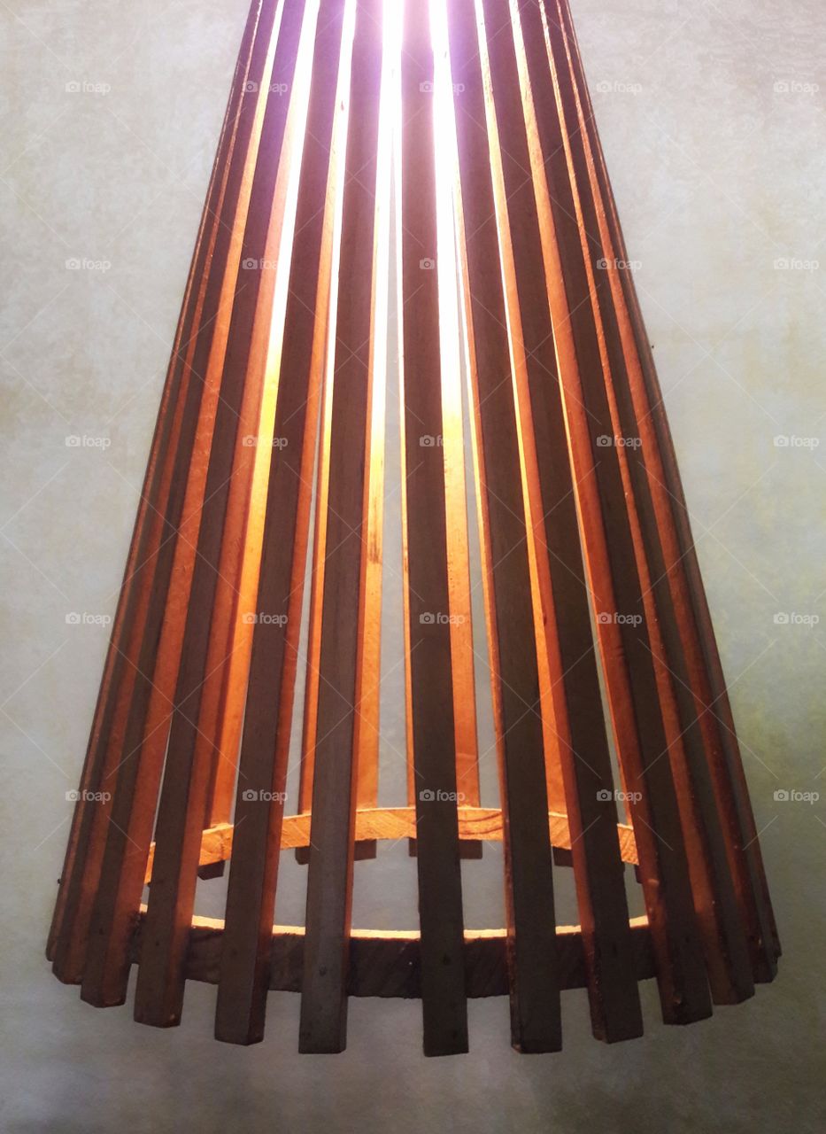 simple wooden light lamp with bulb n back wall paper