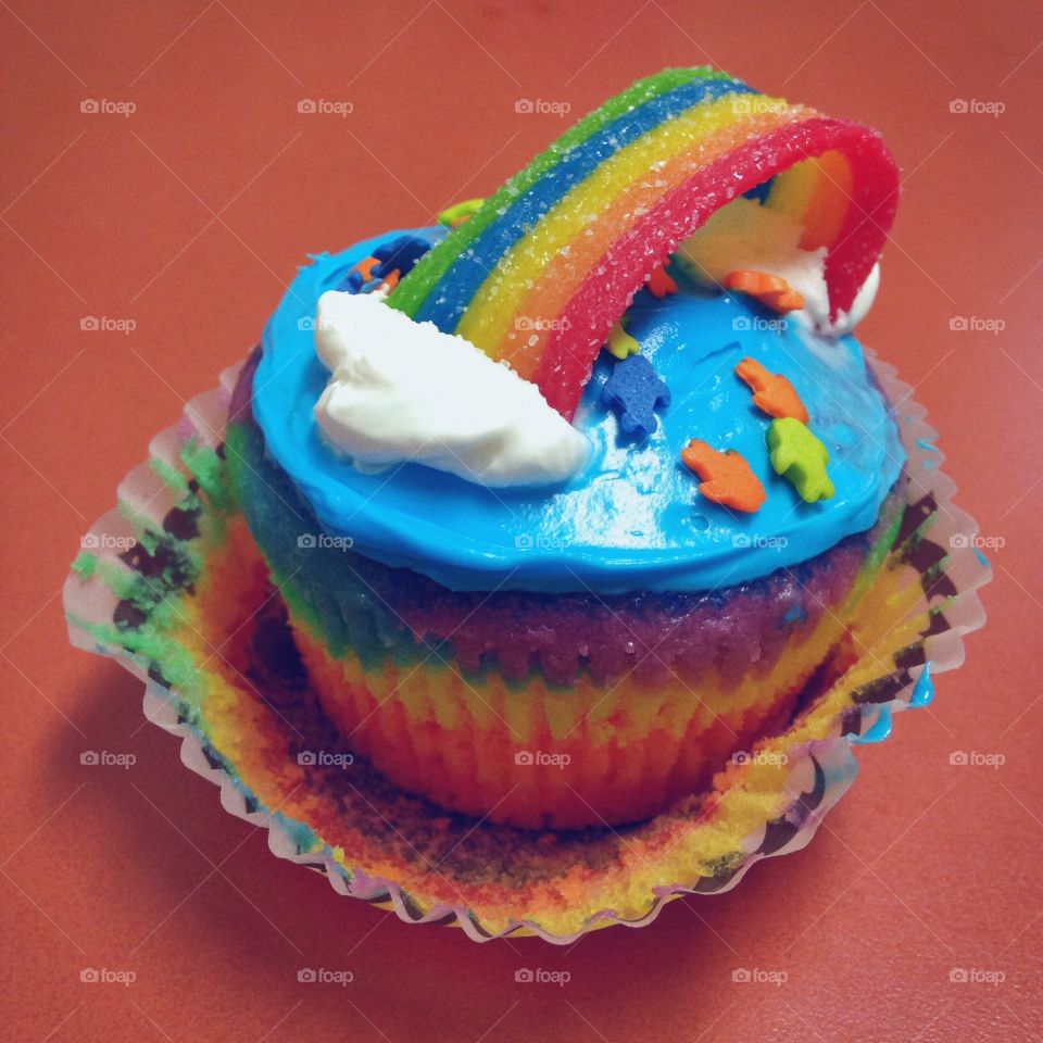 Rainbow Cupcake with Blue Frosting and Sprinkles