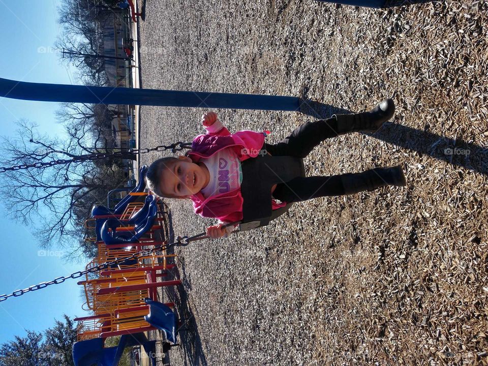 Babygirl Having Fun on the Swings