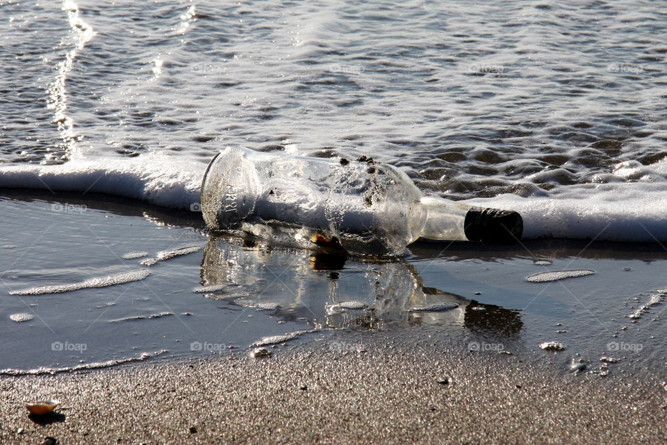 reflected bottle on shore